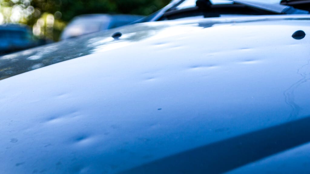 Image of a car that has dents on its roof and qualifies for paintless dent repair