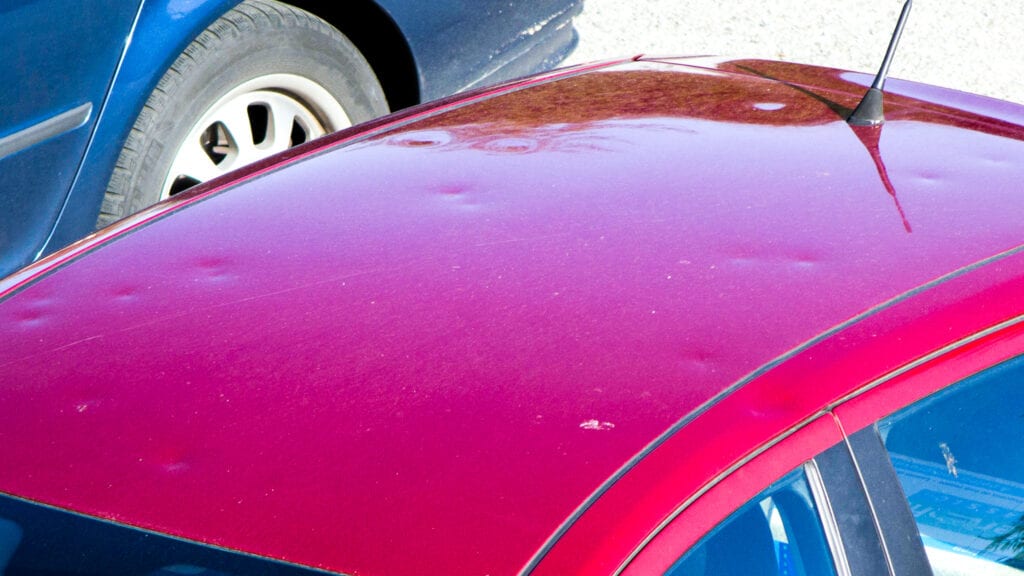 Image of the roof of a car that was damaged by a hailstorm and needs paintless dent repair