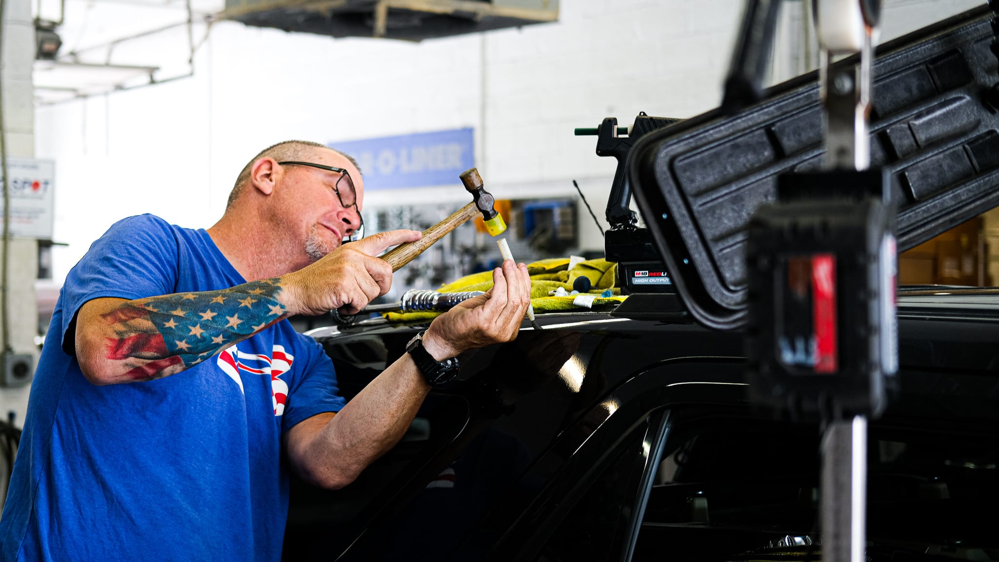 Image of a Conestoga Collision technician performing a paintless dent repair